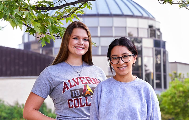 Two students stand outside Alverno's Sr Joel Read Center Rotunda