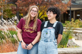 Two Alverno students laughing together outside on campus