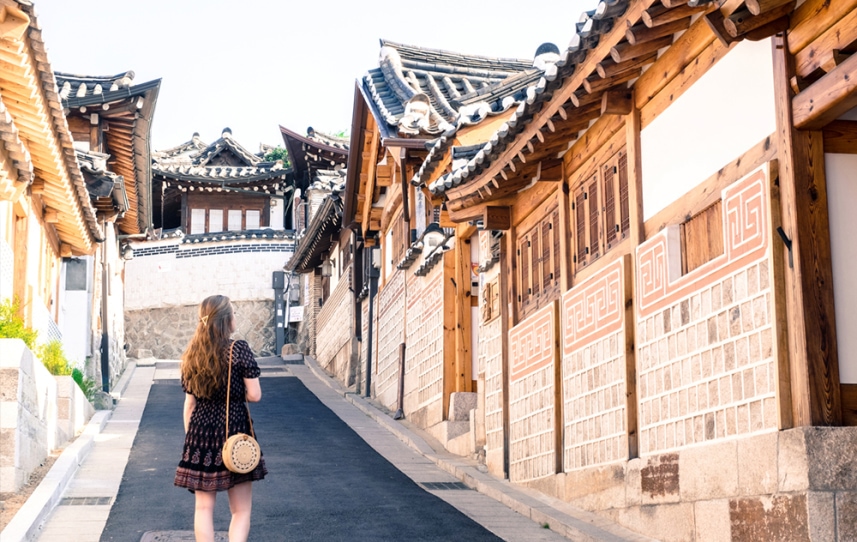 Young woman walks around Seoul, South Korea on her study abroad